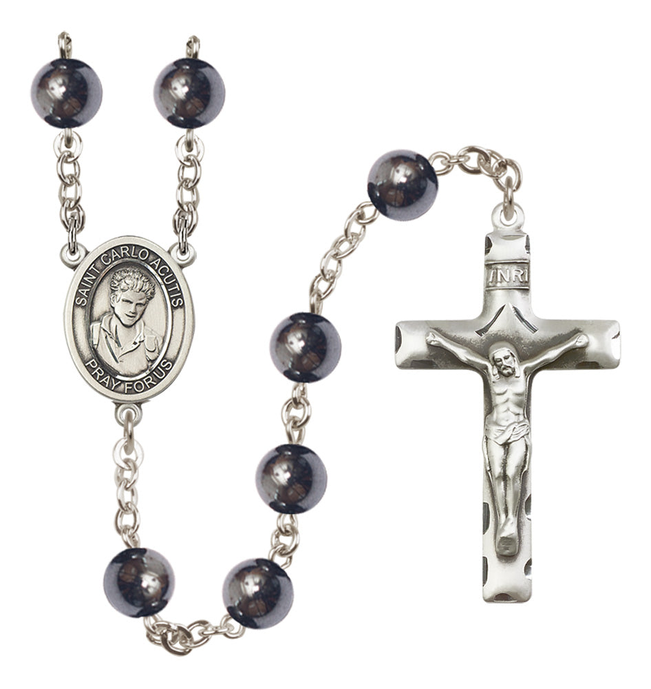 Rosary with black beads and silver cross on a white background