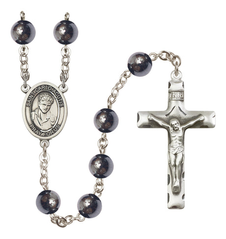 Rosary with black beads and silver cross on a white background