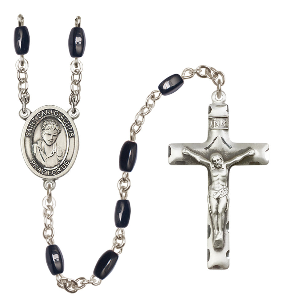 Silver rosary with black beads and crucifix on a white background