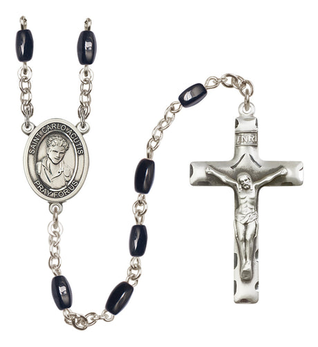 Silver rosary with black beads and crucifix on a white background