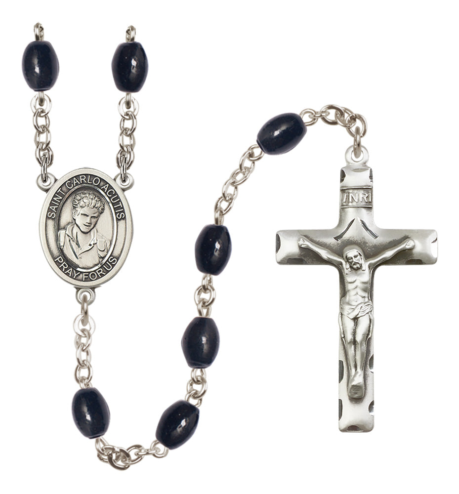 Rosary with black beads and silver cross on a white background