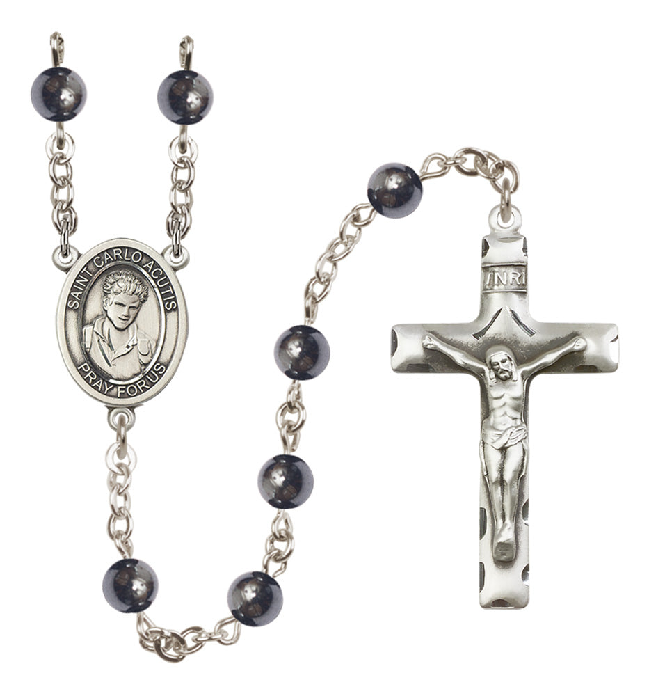 Silver rosary with black beads on a white background