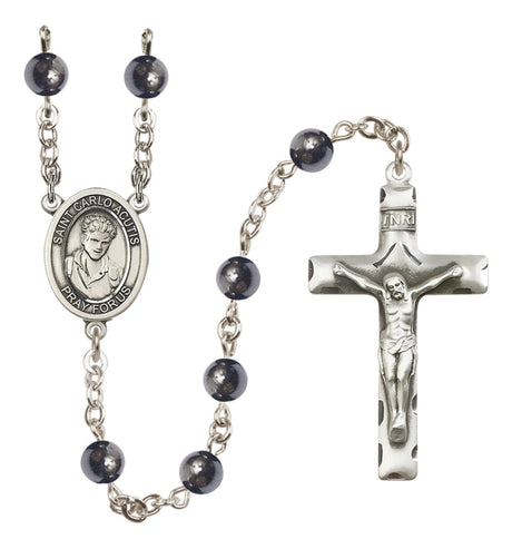 Silver rosary with black beads on a white background