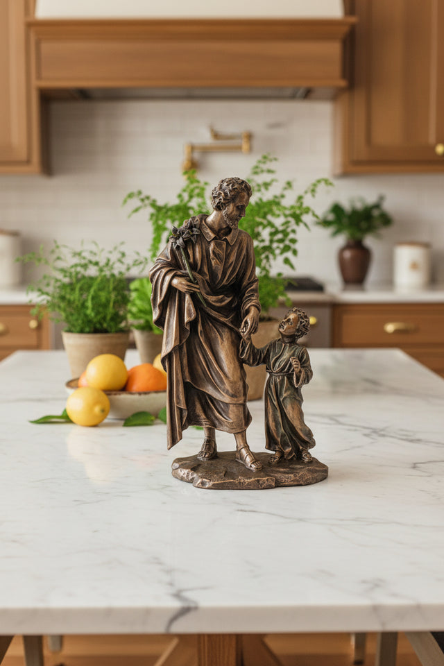 Bronze statue of a man and a child holding hands on a white background